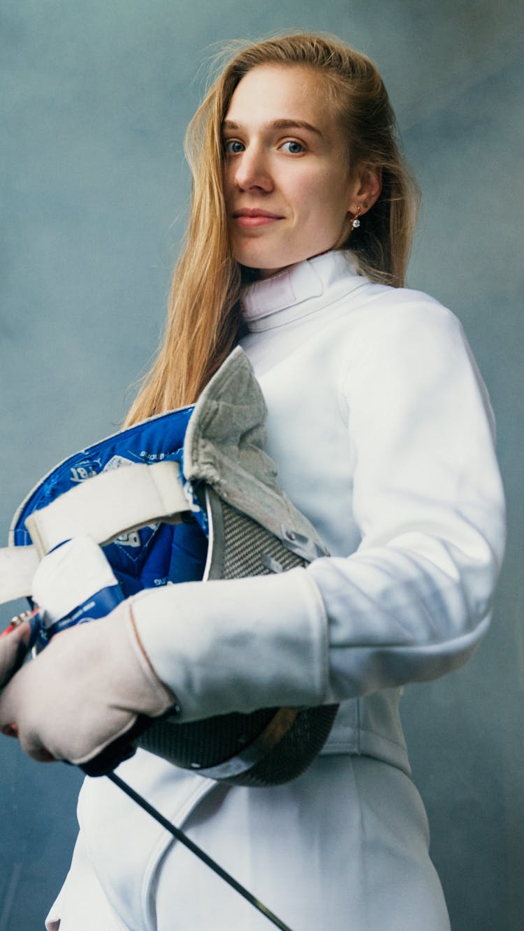 A Woman Holding An Epee Mask