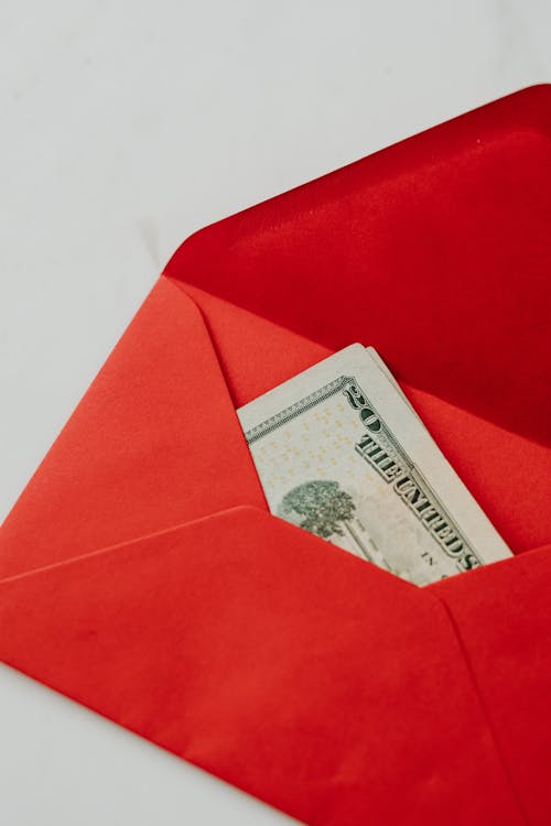 Close-Up Photo of a Twenty Dollar Bill in a Red Envelope