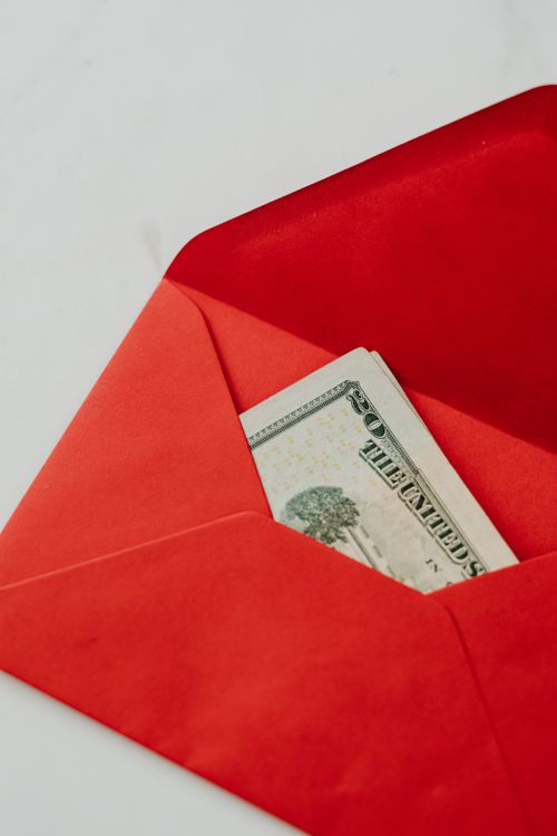 Free Close-up of cash in a red envelope, symbolizing savings and financial planning. Stock Photo