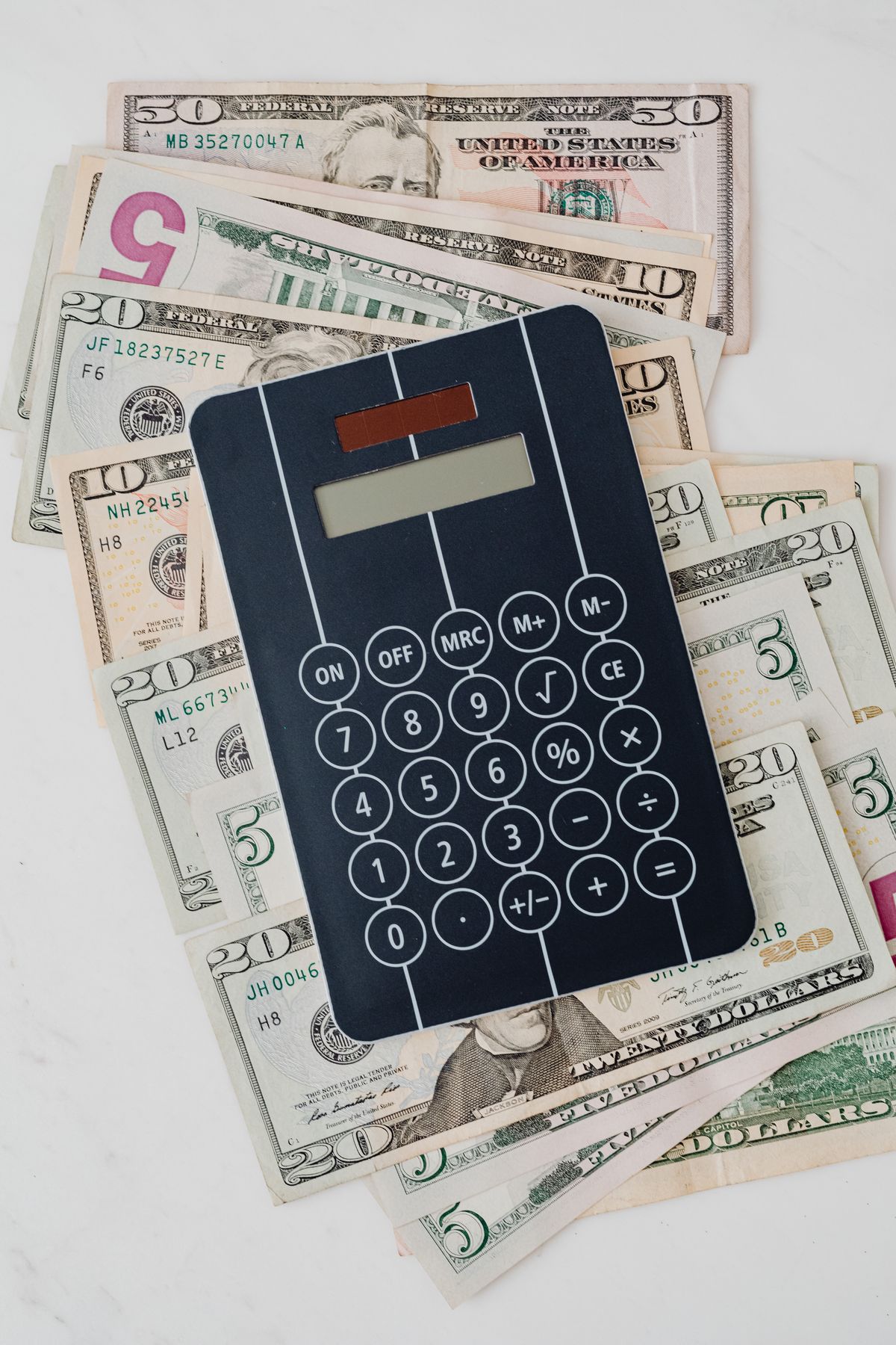 Calculator and money representing savings and financial planning