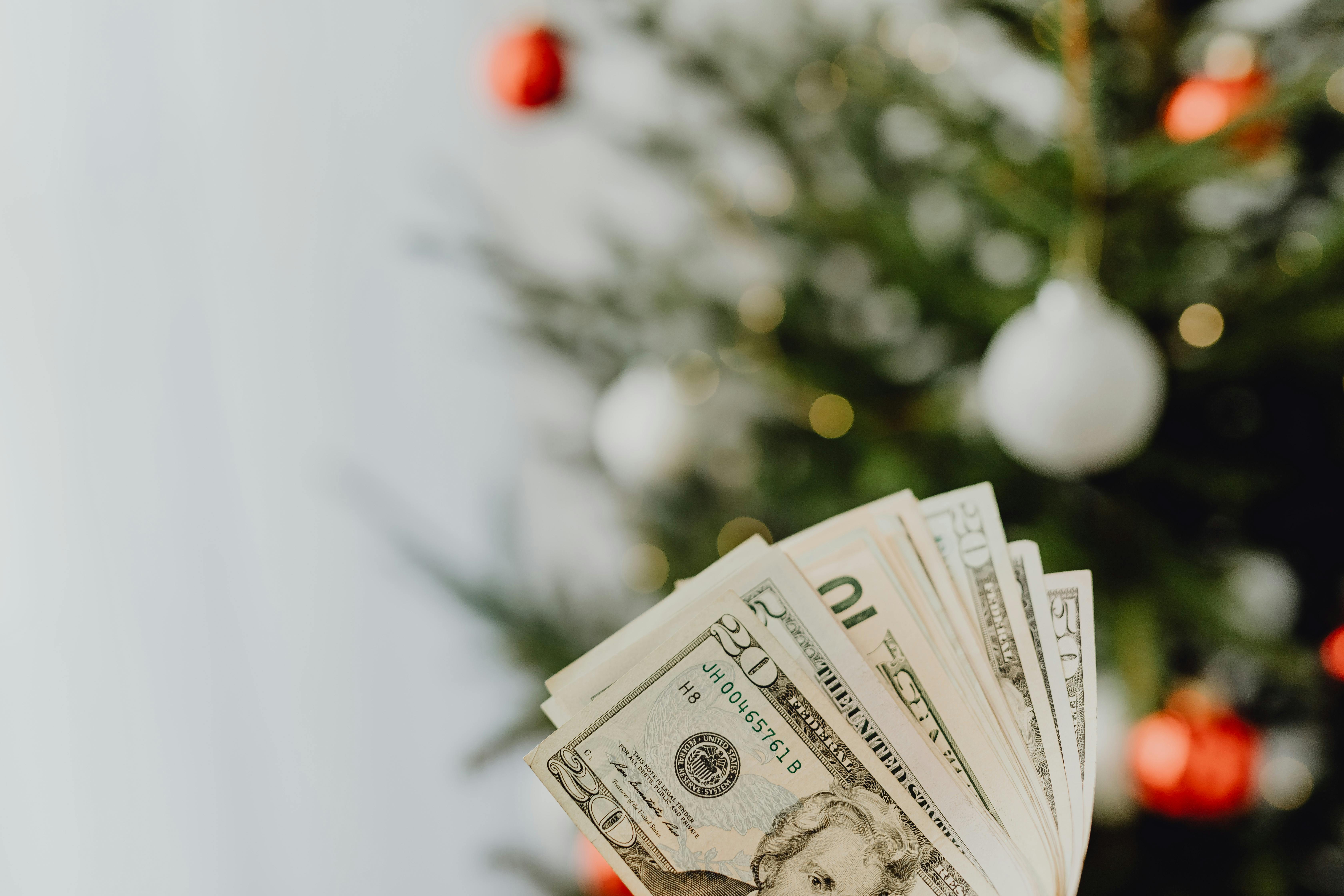 Stack of US dollar bills with a Christmas tree