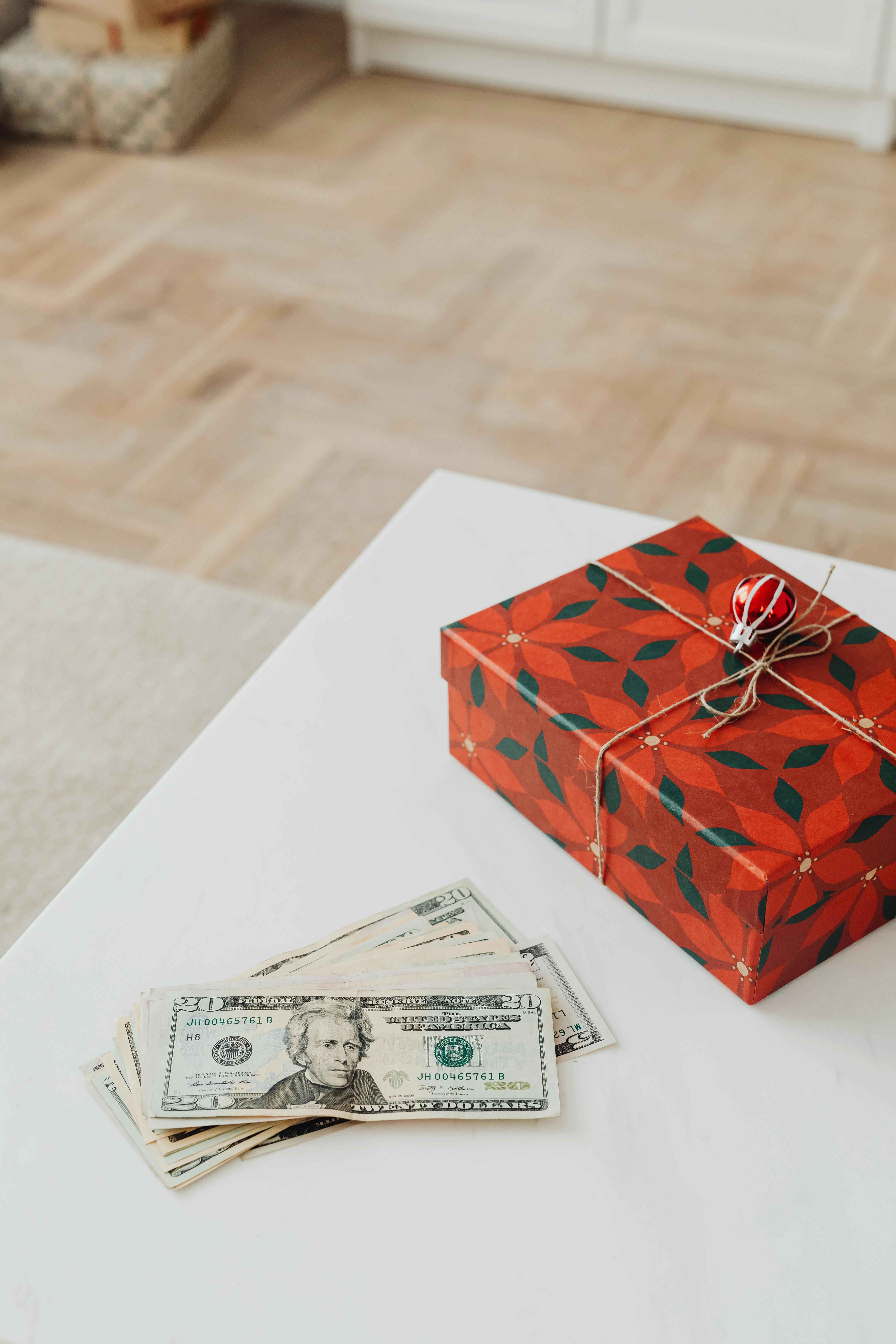 money and a christmas present on a table