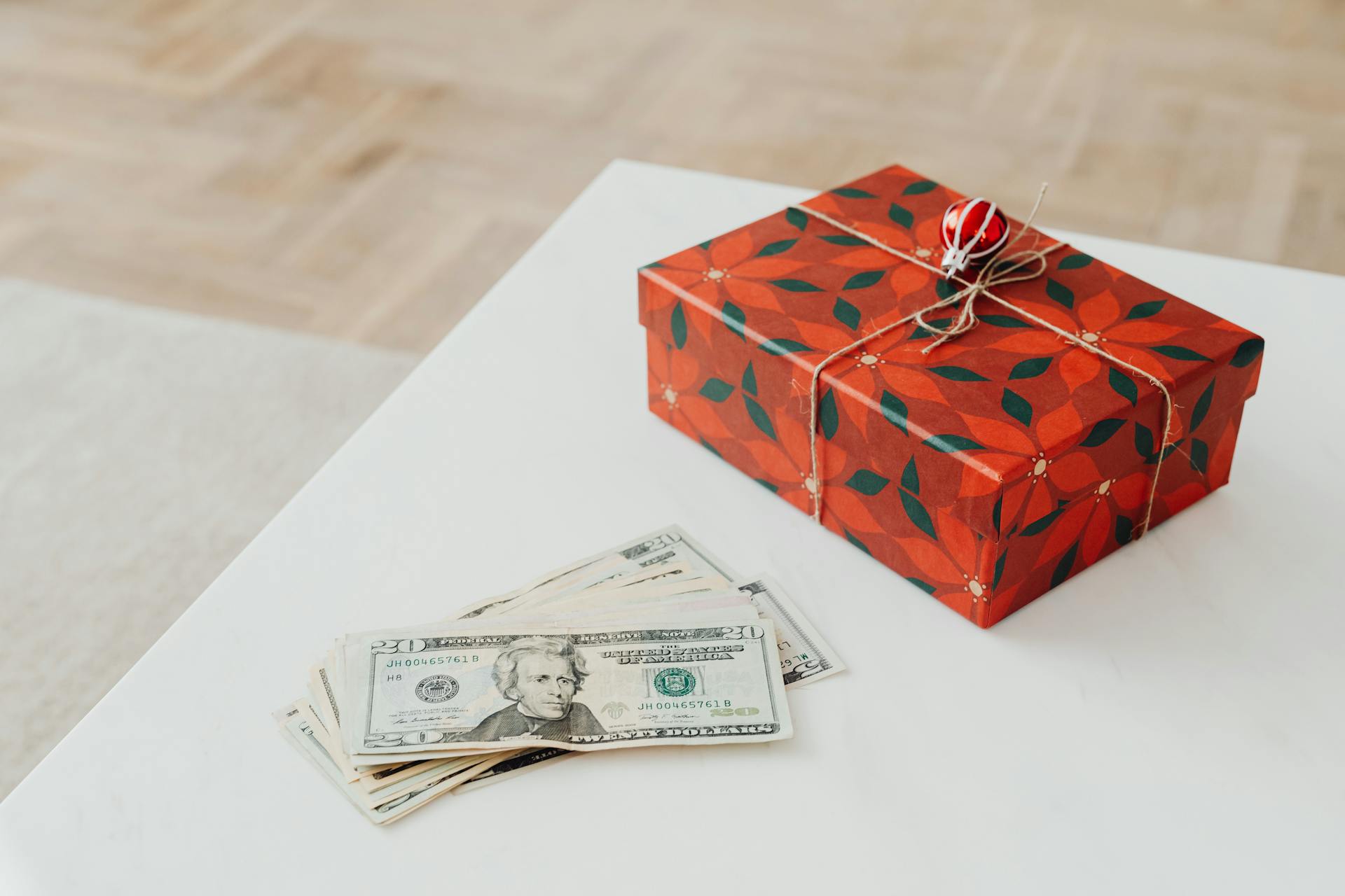 Wrapped Gift and Money Lying on Table