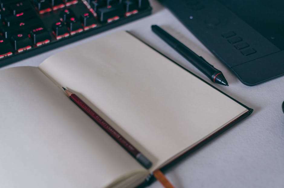 All-Clad D5 vs Tramontina: Value Showdown Open notebook with pencil and stylus on a desk, ideal for creative projects and writing concepts.