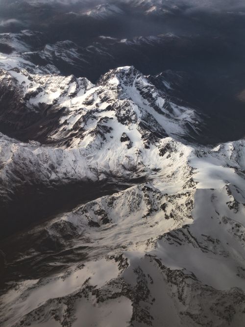 Free Stunning aerial view of the snow-covered Italian Alps showcasing their majestic peaks. Stock Photo