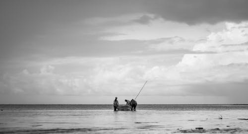 Free Anglers Standing Beside a Fishing Boat Stock Photo