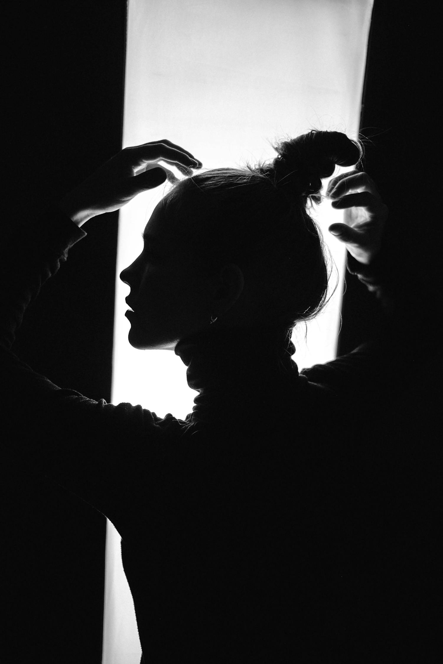 A Silhouette of a Person with Raised Arms