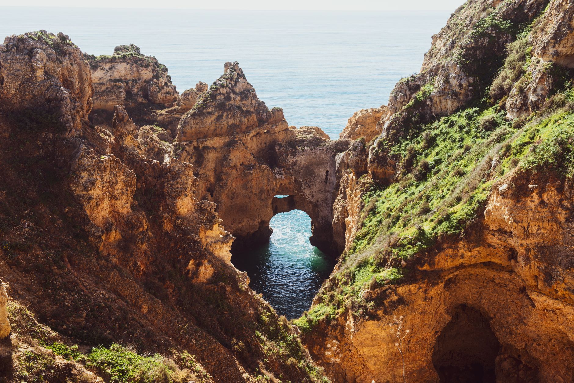 Explore the stunning sea arch and cliffs at Algarve, Portugal, with vibrant natural scenery