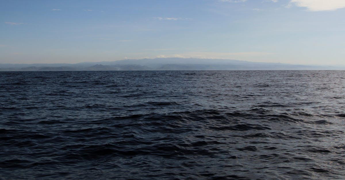 Calm ocean waves under a blue sky near Acajutla, El Salvador coastline.