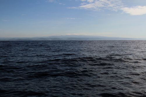 Free Calm ocean waves under a blue sky near Acajutla, El Salvador coastline. Stock Photo
