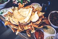 Delicious Middle Eastern mezze platter featuring assorted pita bread, dips like hummus and baba ghanoush.