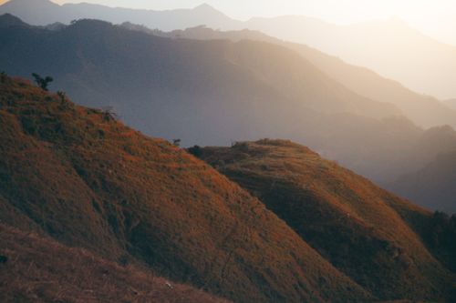 Free A serene mountain landscape bathed in soft golden light, capturing the tranquility of nature. Stock Photo