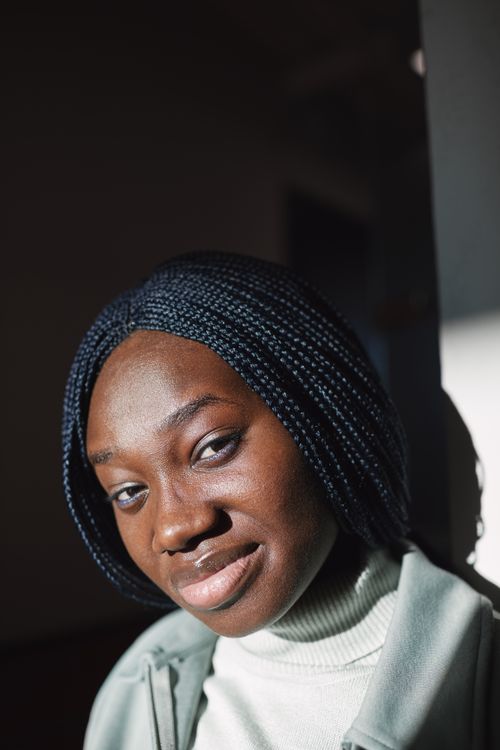 Free Close-up of a woman with braided hair wearing a sweater and turtleneck. Stock Photo