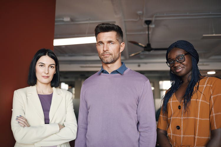 A Group Of People Standing In The Office