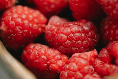 Heap of fresh ripe raspberries in bowl