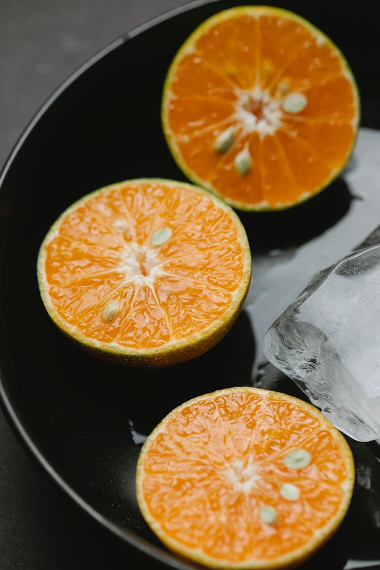 Slices Of Citrus Orange In Bowl With Ice