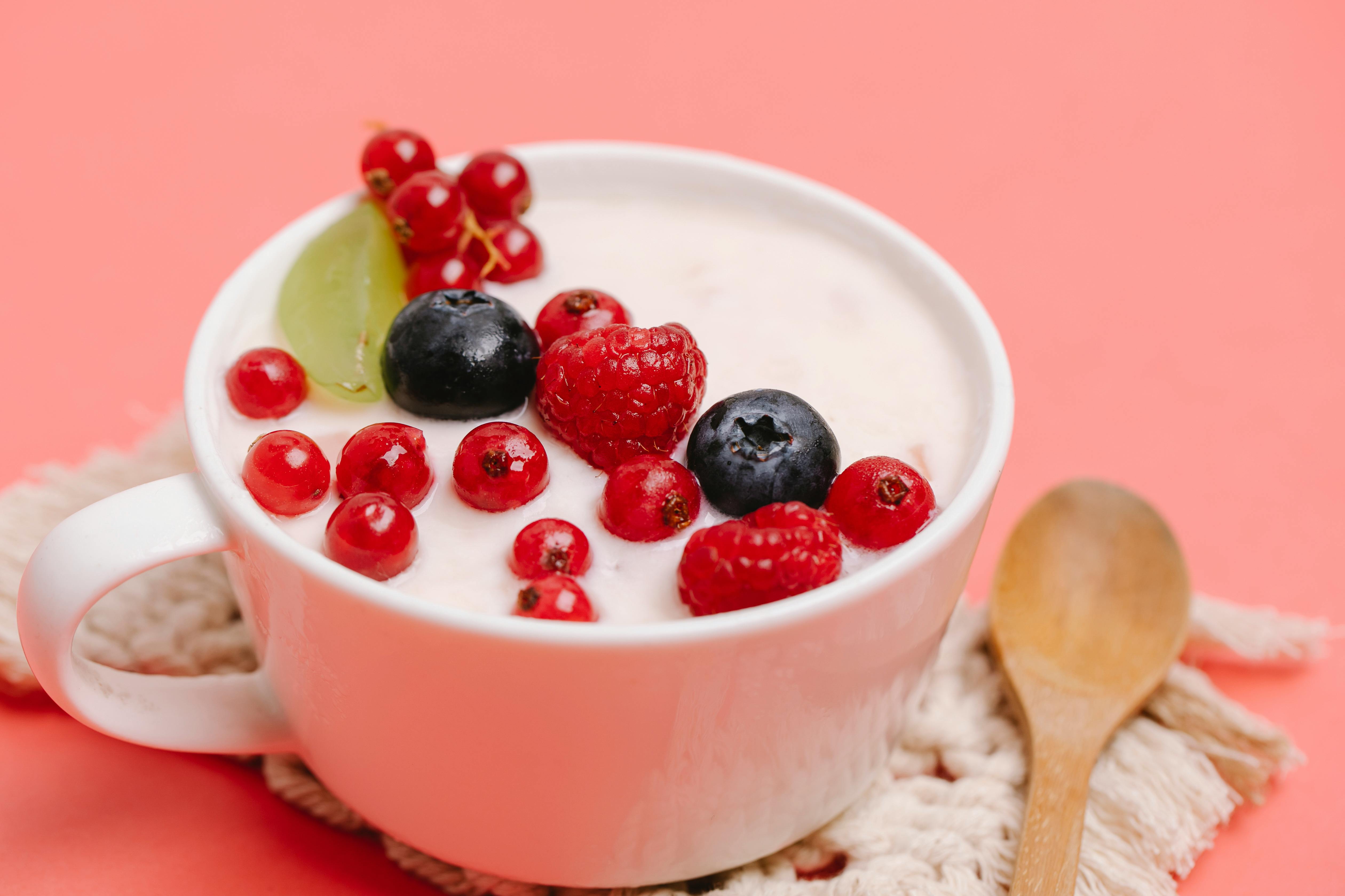 Cup filled with yoghurt and berries
