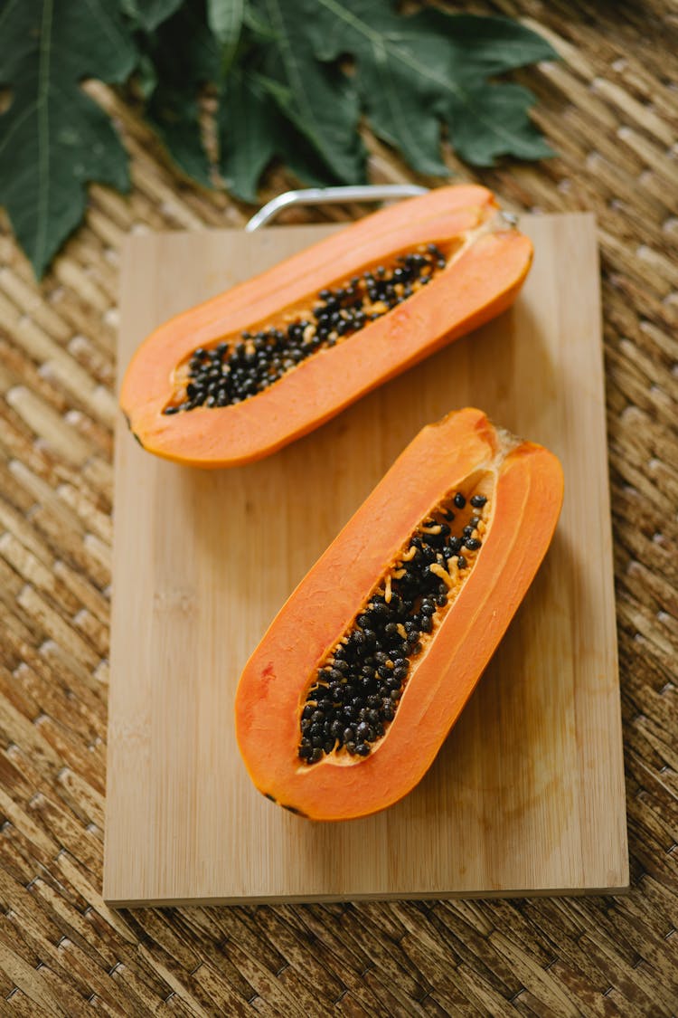 Cut Ripe Exotic Papaya On Wooden Board