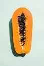 Half of papaya on light background