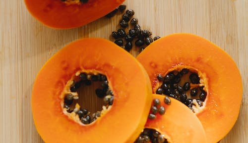 Free Sliced papaya on wooden surface Stock Photo