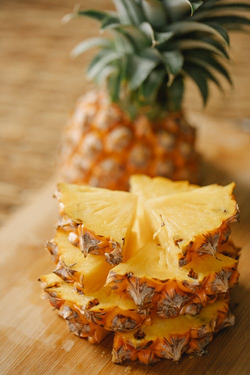 Segments of pineapple arranged on board