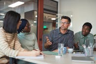 A Group of People Having a Meeting in the Office