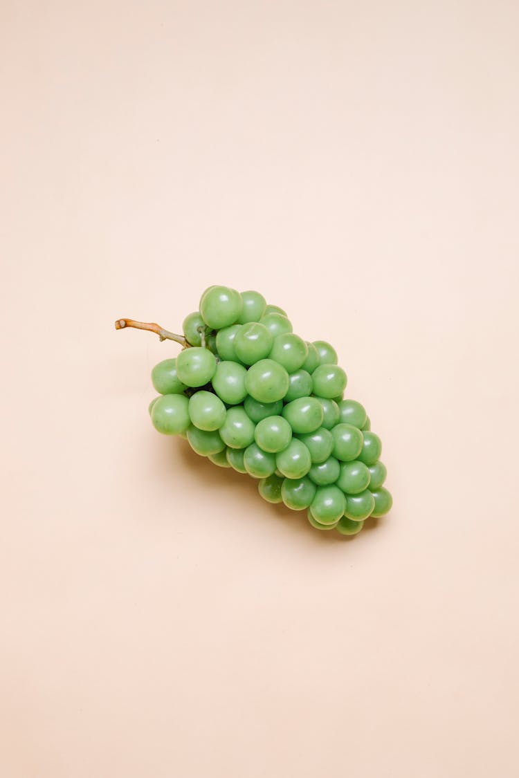 Ripe Green Grapes On Beige Surface