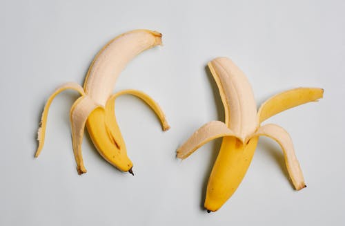 Free Half peeled bananas in yellow skin Stock Photo