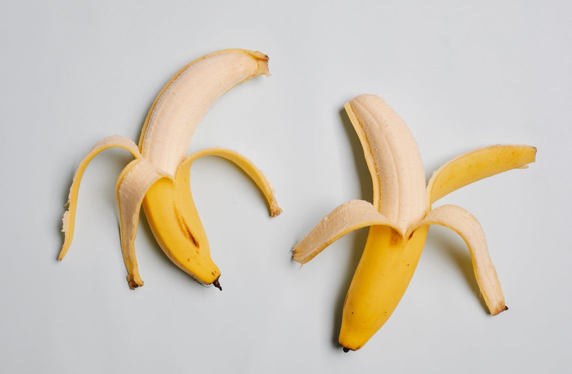 Half peeled bananas in yellow skin