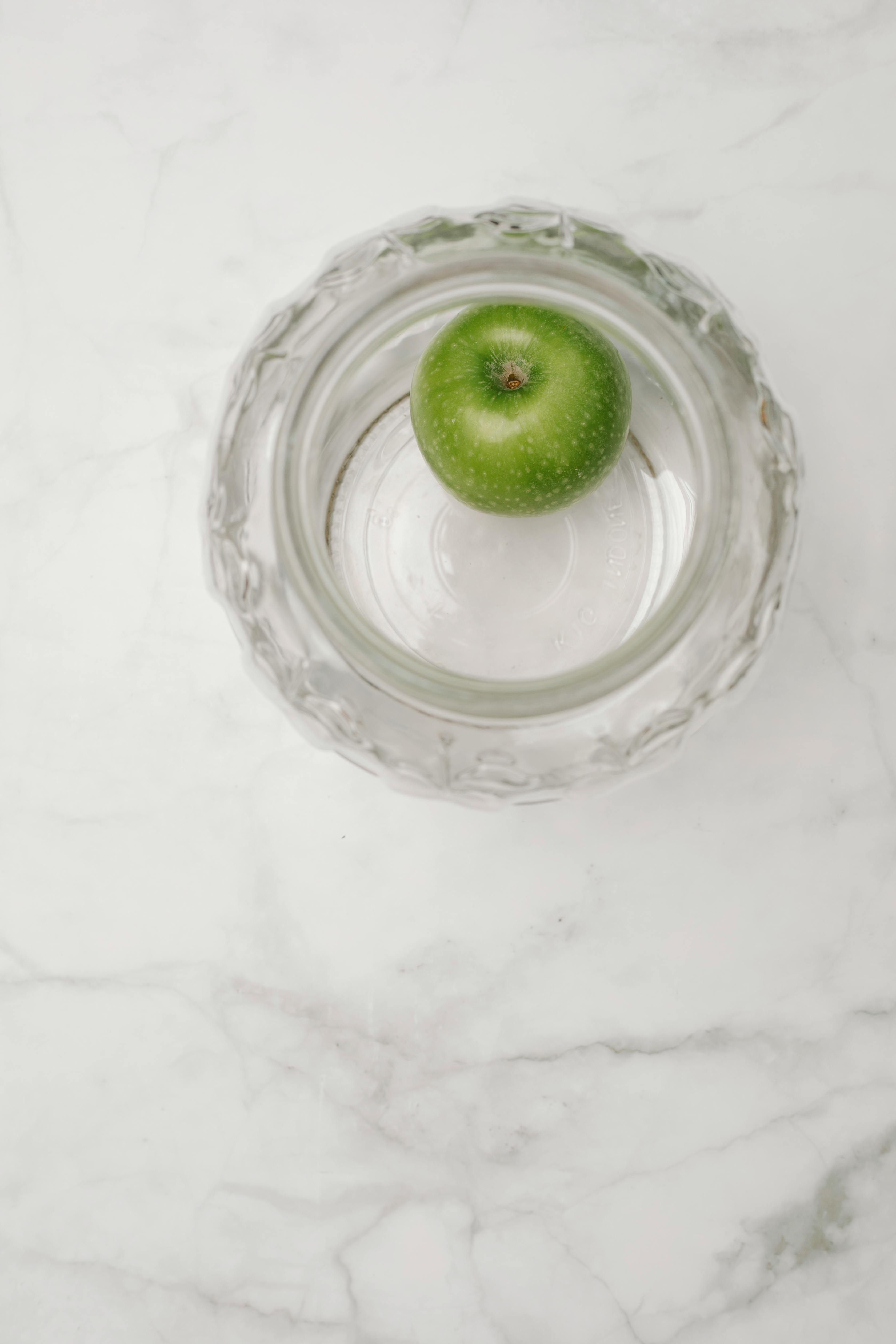 Single green apple in glass bowl · Free Stock Photo
