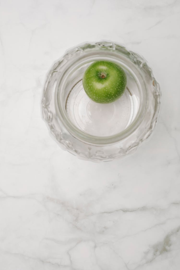 Single Green Apple In Glass Bowl