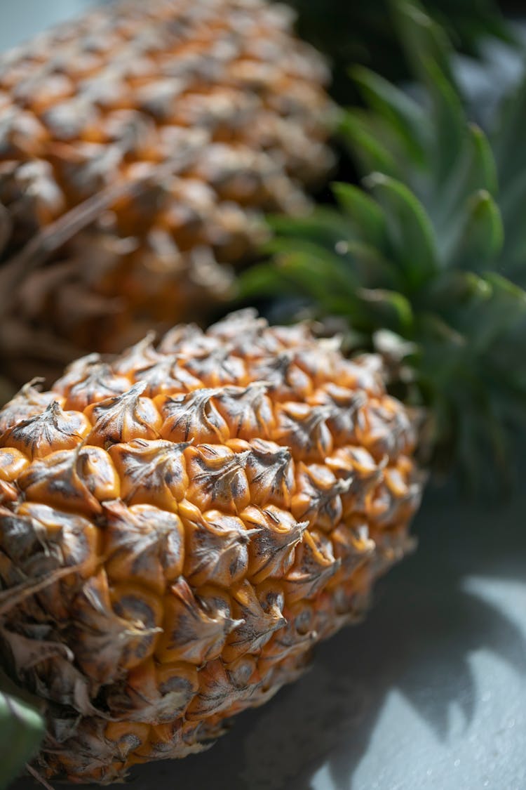 Juicy Whole Pineapples Placed On Light Blue Background