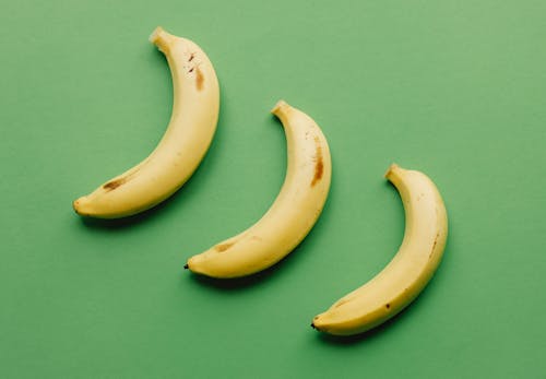Free Ripe bananas on green surface Stock Photo