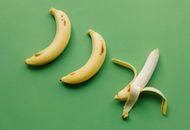 Ripe bananas on green surface