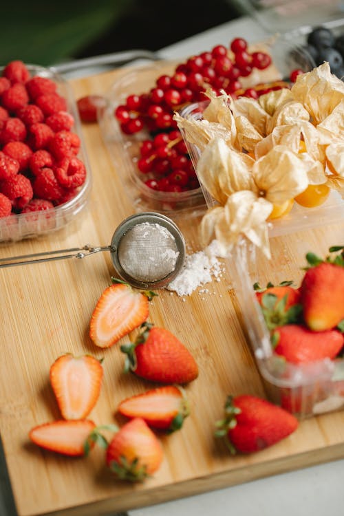 Delicious berries on wooden cutting board