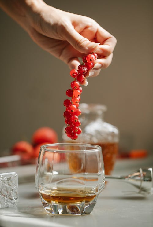 Bunch of berries and glass with cognac