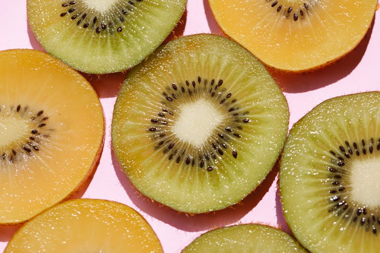 Slices Of Kiwi On Pink Background