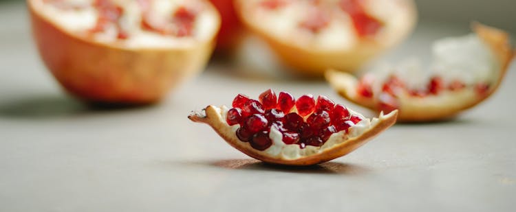 Slice Of Ripe Pomegranate Placed On Table