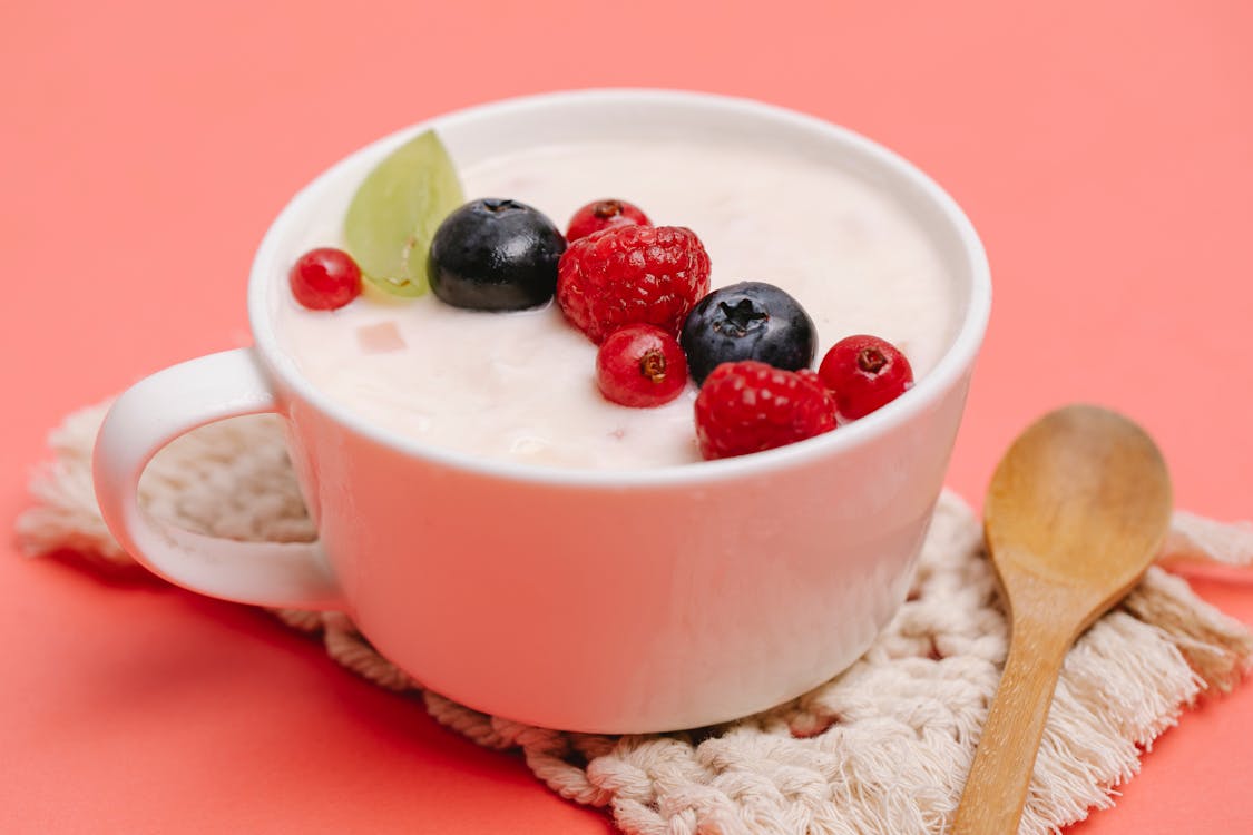 Delicious dessert with berries on coaster