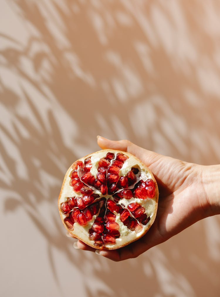 Crop Woman Demonstrating Ripe Pomegranate