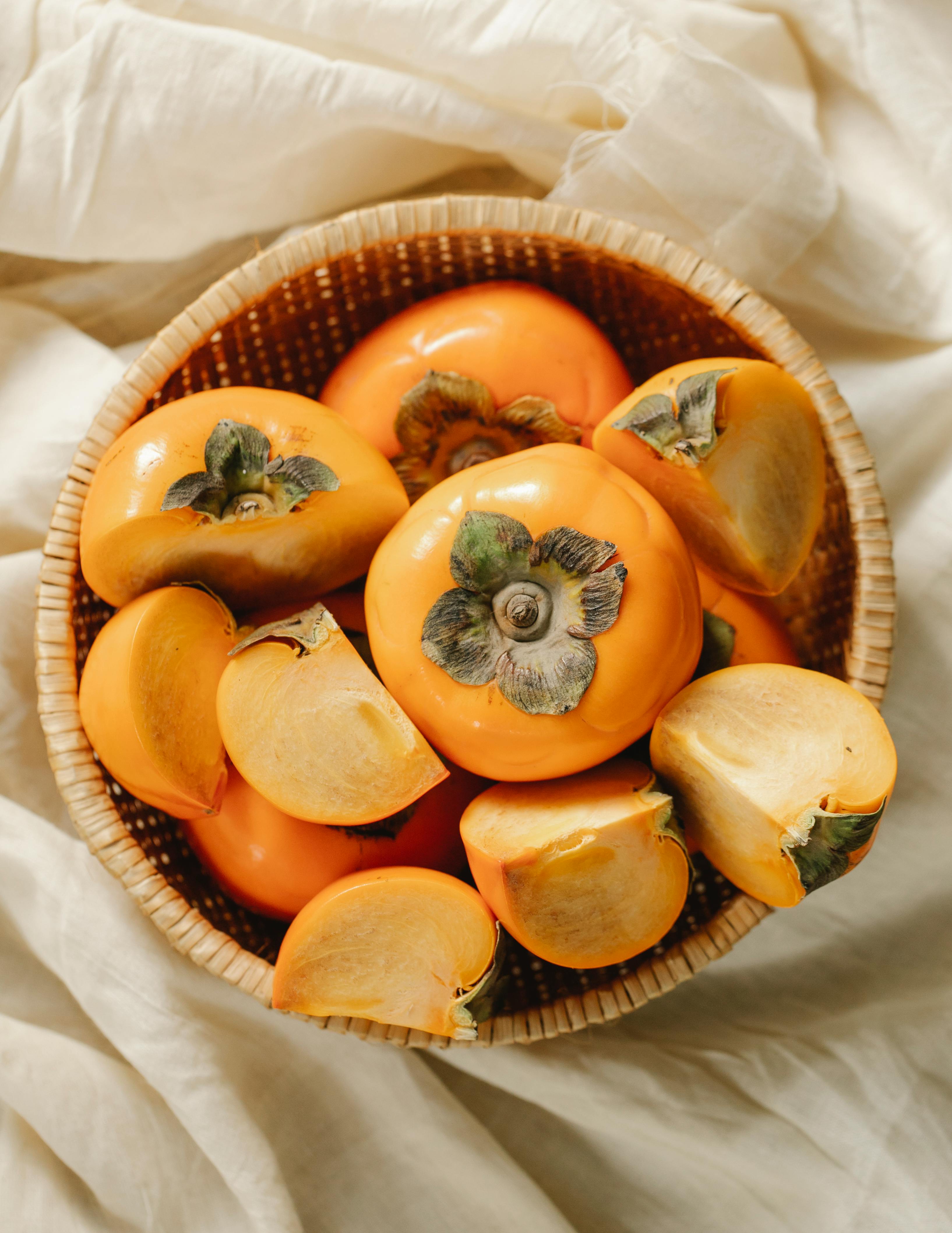 whole and cut fruits of persimmons