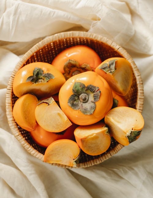 Whole and cut fruits of persimmons