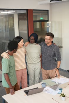 A diverse group of colleagues having a friendly discussion in a modern office setting.