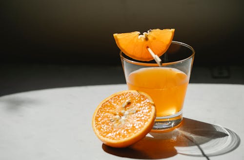 Orange pieces with glass of juice