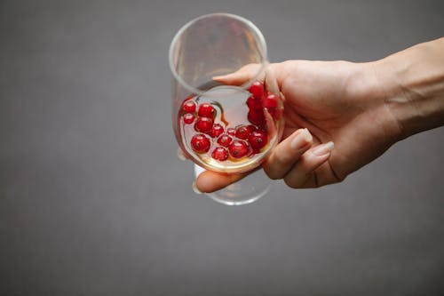 Crop woman with glass of whiskey