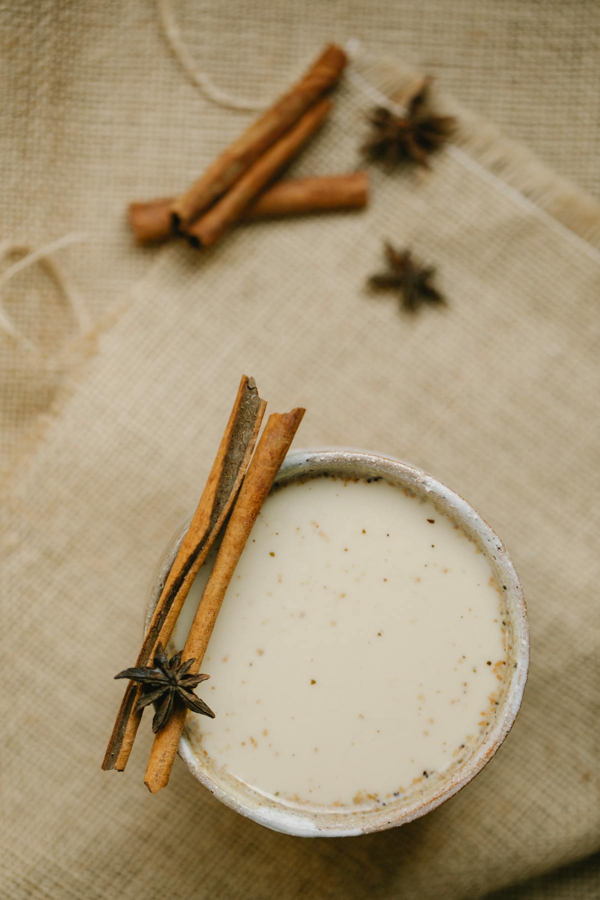 A frothy mushroom latte topped with cinnamon in a ceramic mug