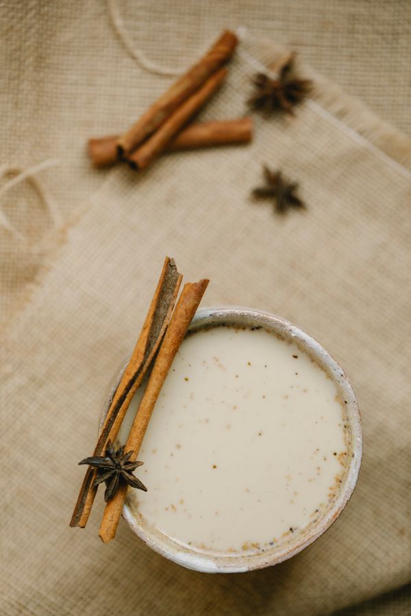 Mug of masala chai with milk and spices