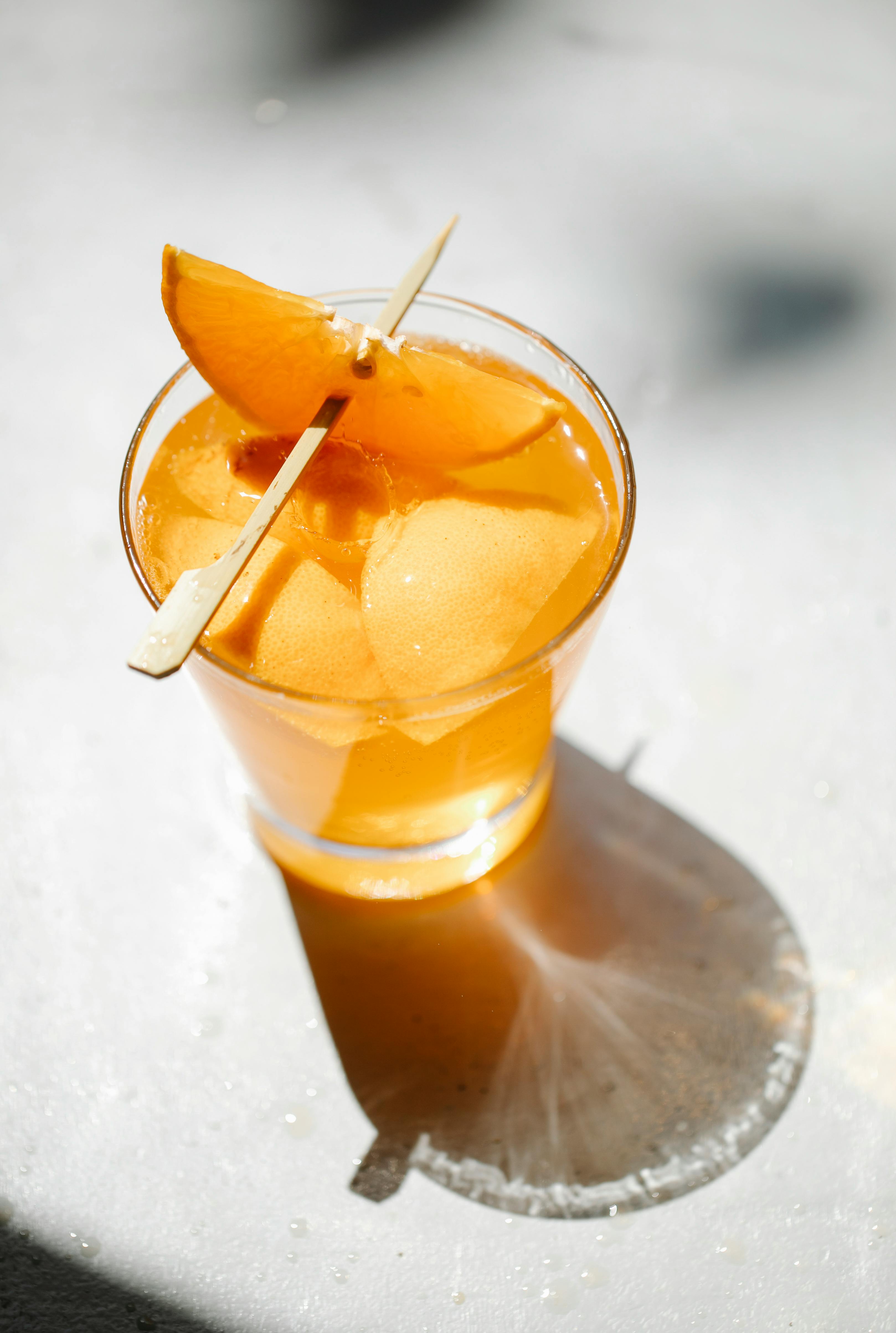 glass of orange drink on table