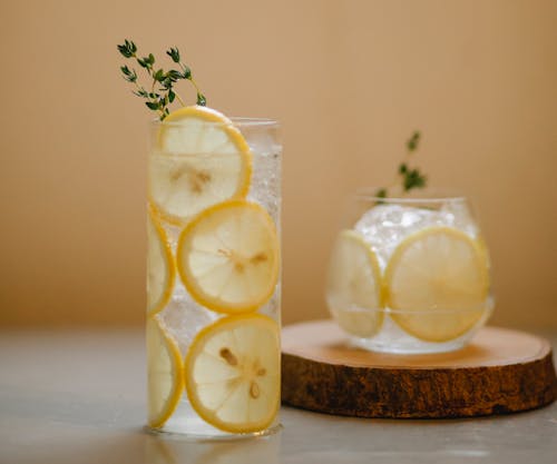 Glasses with lemon drink on table