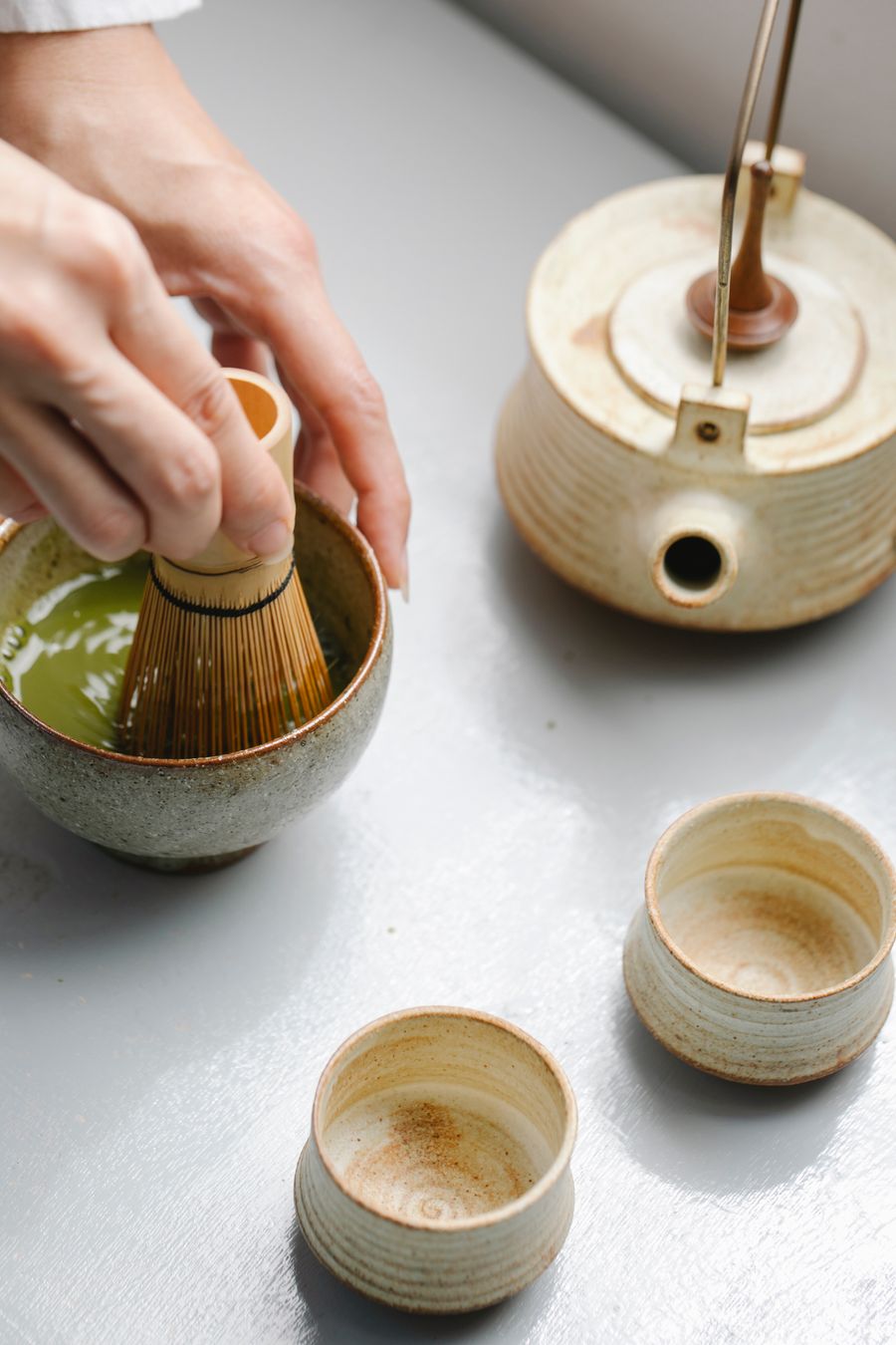 Whisking matcha with a bamboo whisk